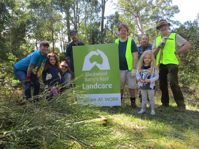 Some of the Blackwood and Barry's Reef Landcare group members with their logo sign